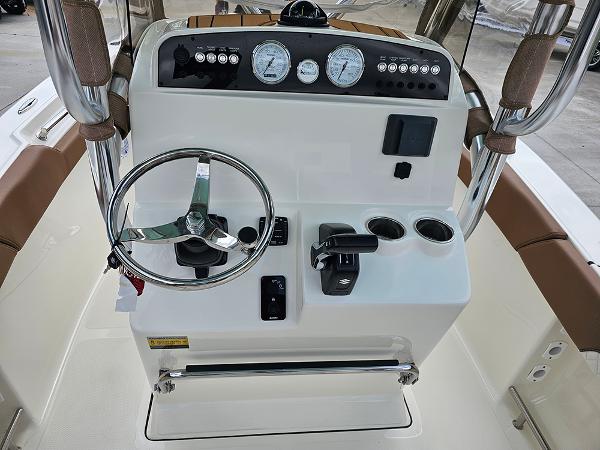 Slide: The Image of 2025 Pioneer 202 Islander boat console with steering wheel, gauges, and controls. - 15
