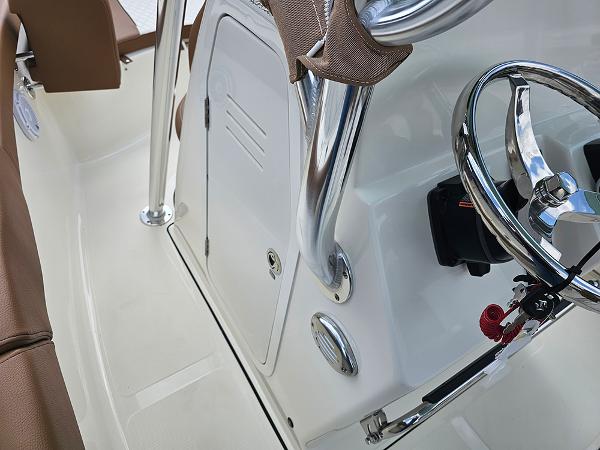 Slide: The Image of 2025 Pioneer 202 Islander boat console with steering wheel and storage compartment. - 16