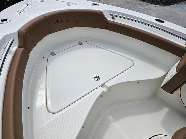 Slide: The Image of 2025 Pioneer 202 Islander boat interior with brown seating and storage compartment. - 19