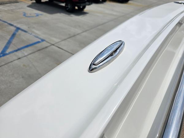 Slide: The Image of 2025 Pioneer 202 Islander boat detail, featuring sleek chrome hardware on a white surface. - 22