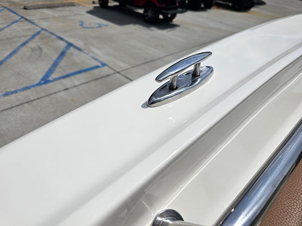Slide: The Image of 2025 Pioneer 202 Islander boat cleat on white deck, parking lot background. - 23