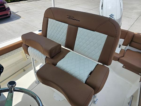 Slide: The Image of 2025 Pioneer 202 Islander boat seating with brown and white quilted upholstery. - 25