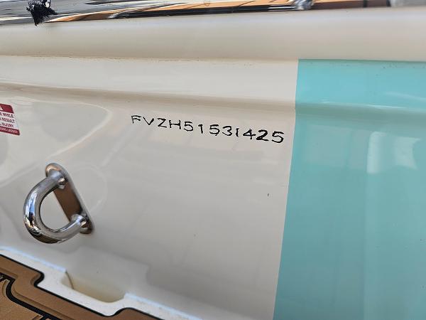 Slide: The Image of 2025 Pioneer 202 Islander boat hull with identification number and metal cleat. - 28