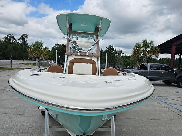 Slide: The Image of 2025 Pioneer 202 Islander boat, front view, parked outdoors under cloudy sky. - 4