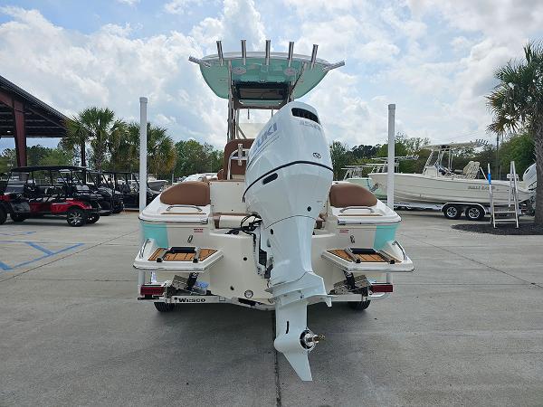 Slide: The Image of 2025 Pioneer 202 Islander boat with outboard motor, parked on concrete under a cloudy sky. - 8