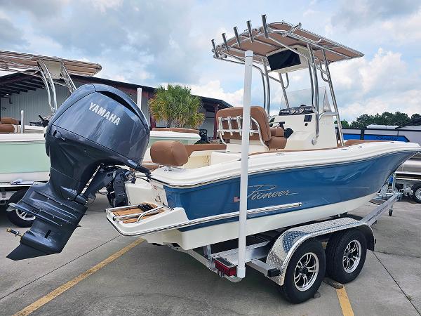 Slide: The Image of 2025 Pioneer 202 Sportfish boat with Yamaha engine on a trailer, parked outdoors. - 5