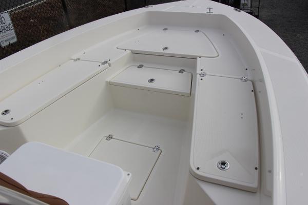 Slide: The Image of 2022 Pioneer 220 Bay Sport boat interior with storage compartments. - 11