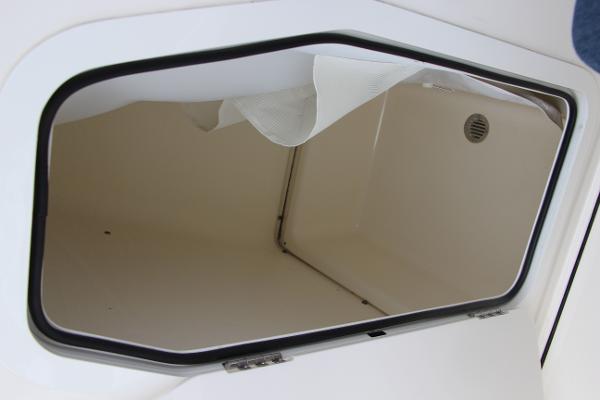 Slide: The Image of Open storage compartment on 2022 Pioneer 220 Bay Sport boat. - 13