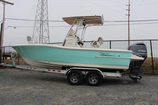 Slide: The Image of 2022 Pioneer 220 Bay Sport boat on trailer, side view, teal color. - 2