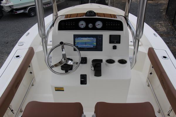 Slide: The Image of 2022 Pioneer 220 Bay Sport boat console with steering wheel and navigation display. - 5