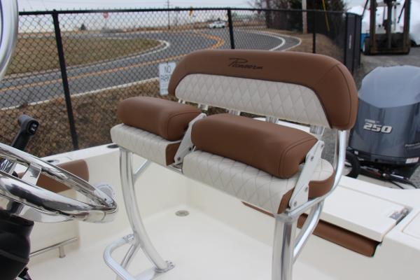 Slide: The Image of 2022 Pioneer 220 Bay Sport boat seating with brown and white upholstery. - 6