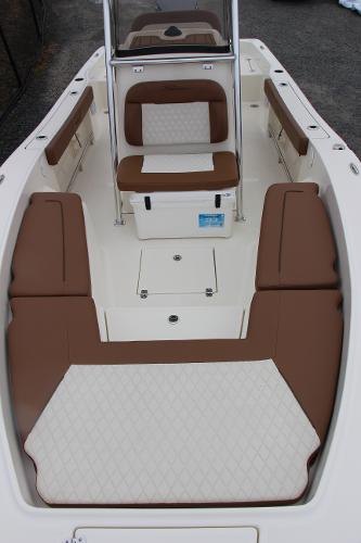 Slide: The Image of 2022 Pioneer 220 Bay Sport boat interior with brown and white seating. - 9