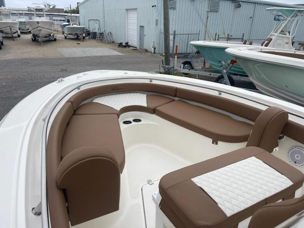 Slide: The Image of 2024 Pioneer 222 Islander boat with brown and white cushioned seating. - 3