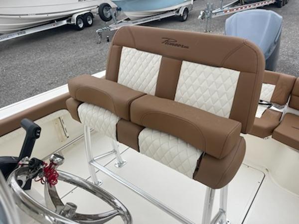 Slide: The Image of 2024 Pioneer 222 Islander boat with brown and white cushioned seating. - 5