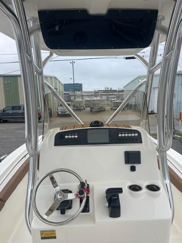 Slide: The Image of 2024 Pioneer 222 Islander boat console with steering wheel and controls. - 6