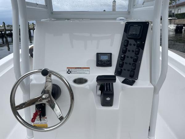 Slide: The Image of 2024 Polar 220 CC boat console with steering wheel and control panel. - 2
