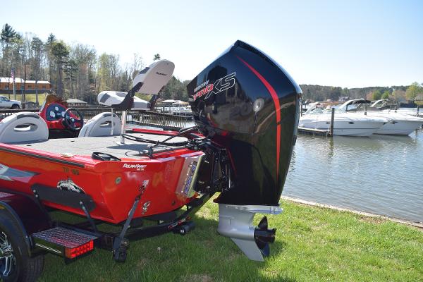 Slide: The Image of 2022 Polar Kraft Bass TX 195 Pro boat with powerful outboard motor by a lakeside. - 1