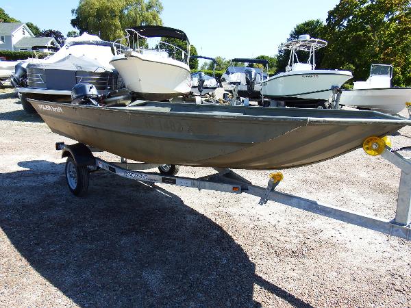 Slide: The Image of 2018 Polar Kraft Jon 1448 LW boat on a trailer in a marina. - 8