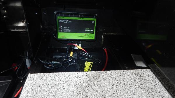 Slide: The Image of Battery compartment of 2024 Polar Kraft Outlander 186 SC boat with RealPRO battery charger. - 13
