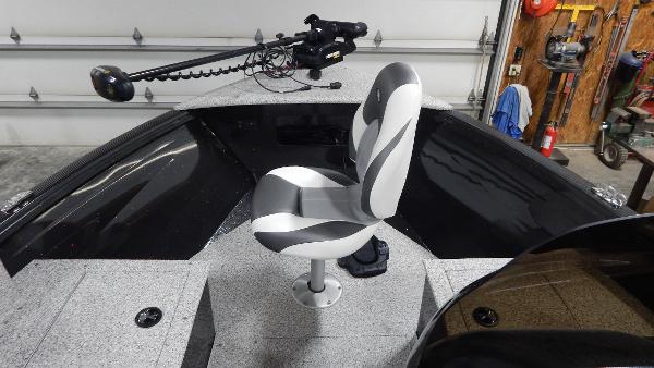 Slide: The Image of 2024 Polar Kraft Outlander 186 SC boat interior with swivel seat and mounted trolling motor. - 24