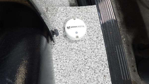 Slide: The Image of Minn Kota device on 2024 Polar Kraft Outlander 186 SC boat's carpeted floor. - 28