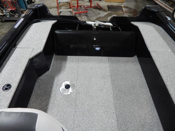 Slide: The Image of 2024 Polar Kraft Outlander 186 SC boat interior with gray flooring and seating. - 40