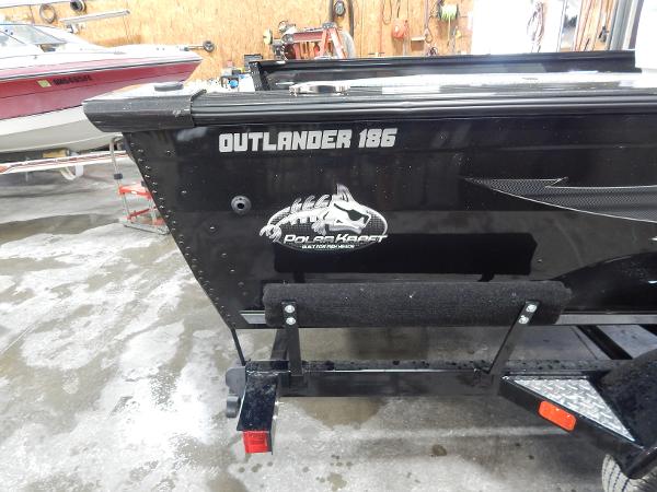 Slide: The Image of 2024 Polar Kraft Outlander 186 SC boat in a garage. - 42