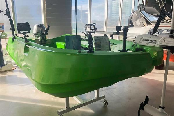 Slide: The Image of 2021 Polycraft 300 Tuffy green boat with mounted equipment in showroom. - 1