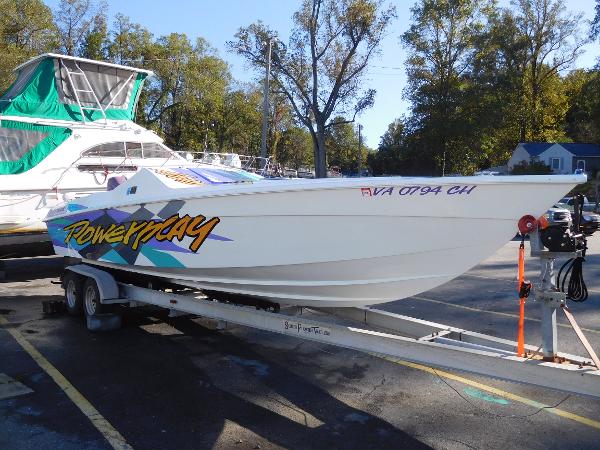 Slide: The Image of 1997 Powerplay Powerboats 28 Sport Deck on trailer, vibrant graphics, parked outdoors. - 0