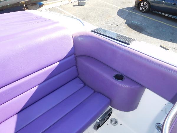 Slide: The Image of 1997 Powerplay Powerboats 28 Sport Deck with purple seating and cup holder. - 12