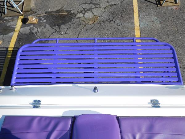 Slide: The Image of 1997 Powerplay Powerboats 28 Sport Deck with purple seating and deck railing. - 14