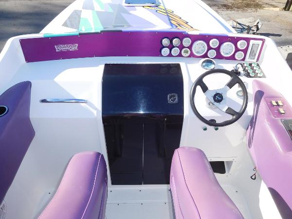 Slide: The Image of 1997 Powerplay Powerboats 28 Sport Deck with purple dashboard and steering wheel. - 15