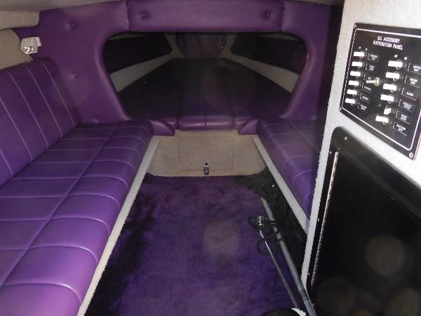 Slide: The Image of 1997 Powerplay Powerboats 28 Sport Deck interior with purple seating and control panel. - 21