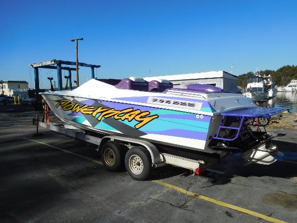 Slide: The Image of 1997 Powerplay Powerboats 28 Sport Deck on trailer, vibrant graphics, parked outdoors. - 3