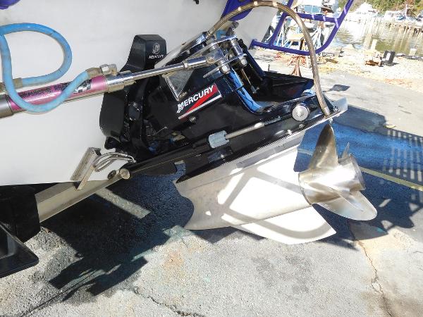 Slide: The Image of 1997 Powerplay Powerboats 28 Sport Deck with Mercury outboard motor and propeller. - 30