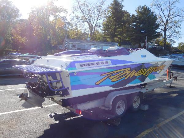 Slide: The Image of 1997 Powerplay Powerboats 28 Sport Deck on trailer, vibrant graphics, sunny day. - 4