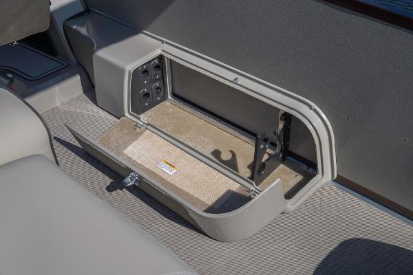Slide: The Image of 2023 Premier 220 Castaway storage compartment with open lid. - 14