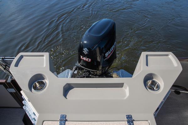 Slide: The Image of 2023 Premier 220 Castaway boat with Suzuki 140 outboard motor on water. - 18