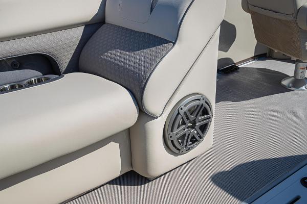 Slide: The Image of 2023 Premier 220 Castaway boat interior with speaker and cushioned seating. - 24