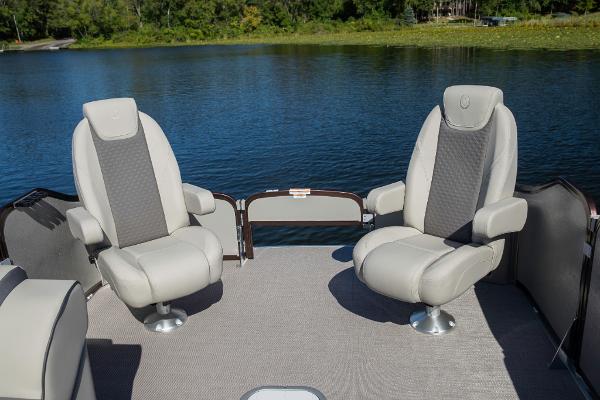 Slide: The Image of 2023 Premier 220 Castaway boat with two comfortable seats on a lake. - 25