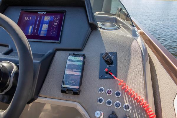 Slide: The Image of 2023 Premier 220 Castaway boat dashboard with navigation screen and controls. - 28