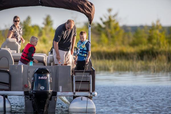 Slide: The Image of Family enjoying a day on a 2023 Premier 220 Castaway pontoon boat. - 3