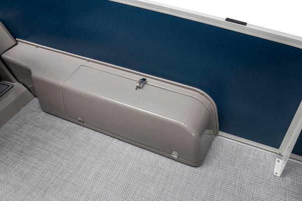Slide: The Image of 2023 Premier 220 Castaway storage compartment on carpeted boat floor. - 37