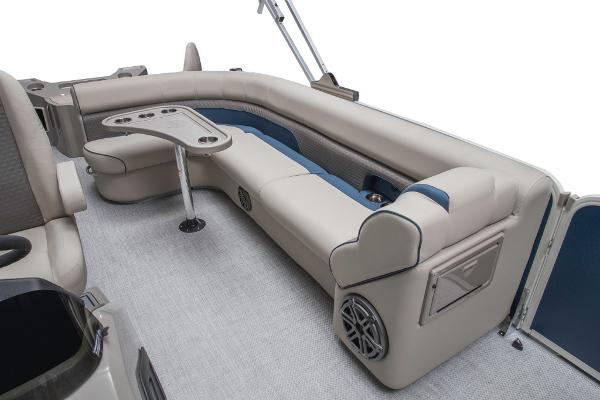 Slide: The Image of 2023 Premier 220 Castaway boat interior with beige seating and table. - 39