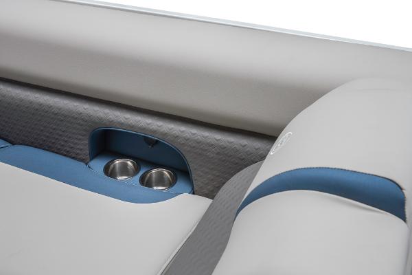 Slide: The Image of 2023 Premier 220 Castaway boat interior with cup holders and cushioned seating. - 44