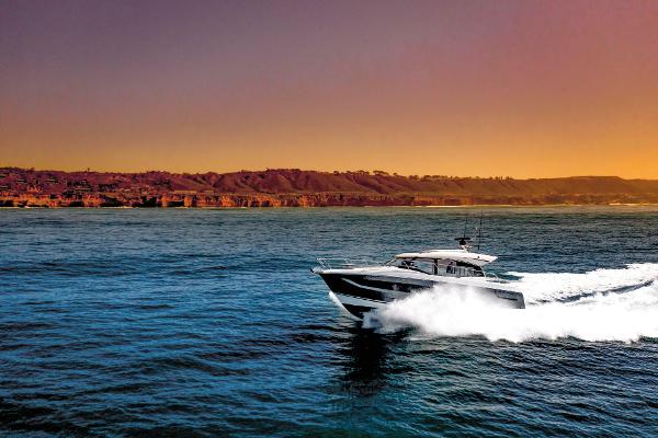 Slide: The Image of Luxury Prestige 420S yacht cruising at sunset, 2025 model, near scenic coastline. - 0