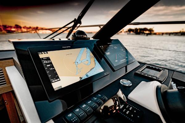 Slide: The Image of Prestige 420S 2025 yacht dashboard with navigation screens at sunset. - 4