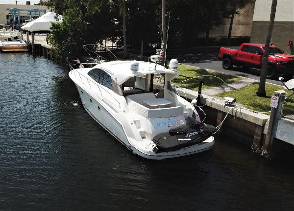 Slide: The Image of 2013 Prestige 440 S yacht docked in a marina, rear view. - 1