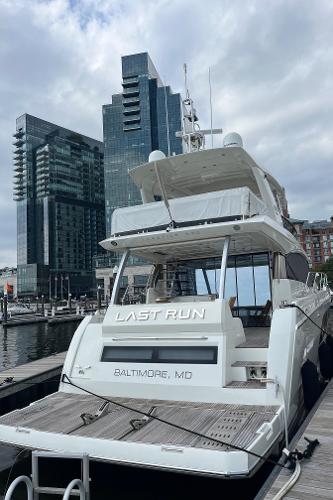 Slide: The Image of Luxury 2017 Prestige 63 yacht docked in Baltimore with city skyline backdrop. - 1