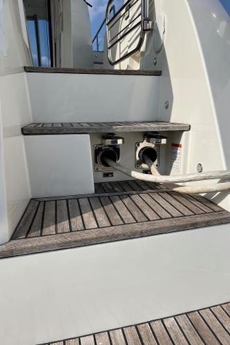 Slide: The Image of Staircase on 2017 Prestige 63 yacht with wooden steps and utility connections. - 14